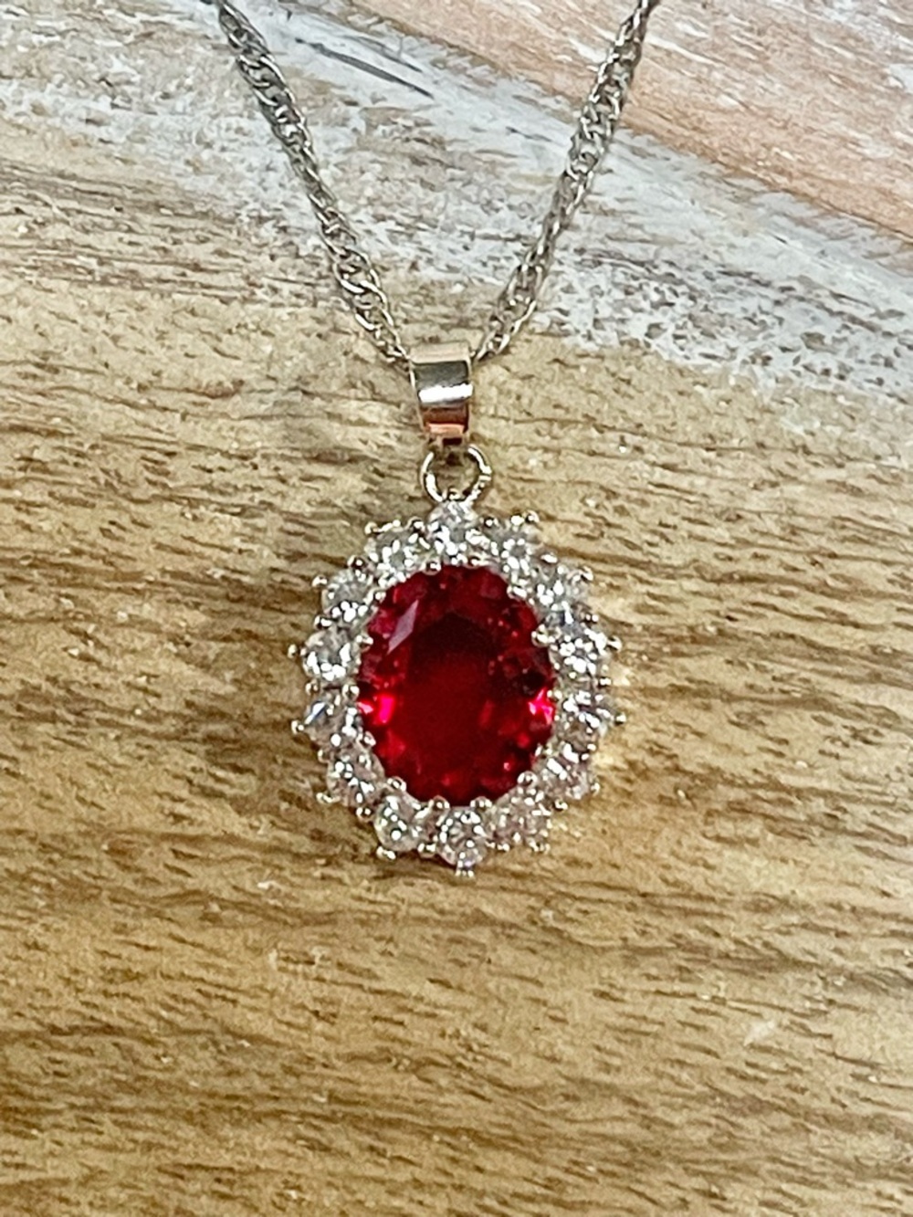 Ruby Red Crystal Halo Pendant Necklace Set in a Silvertone Setting